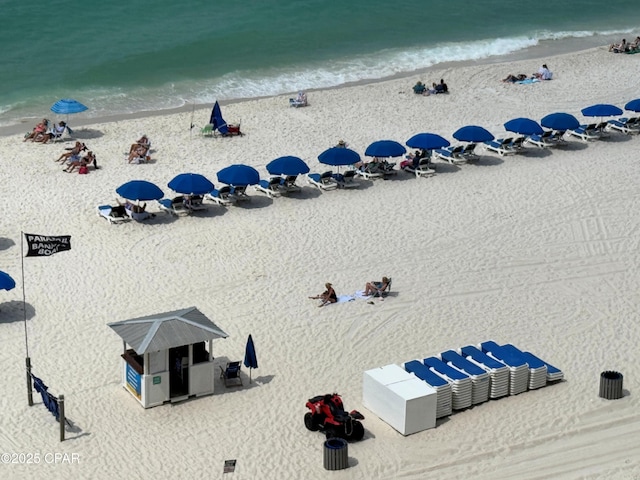 drone / aerial view with a water view and a view of the beach
