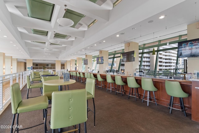 dining space with beam ceiling, recessed lighting, coffered ceiling, carpet flooring, and wet bar
