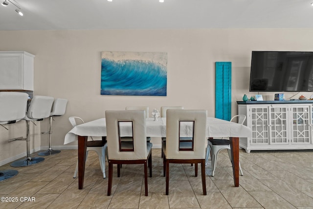 dining room featuring light tile patterned flooring and baseboards