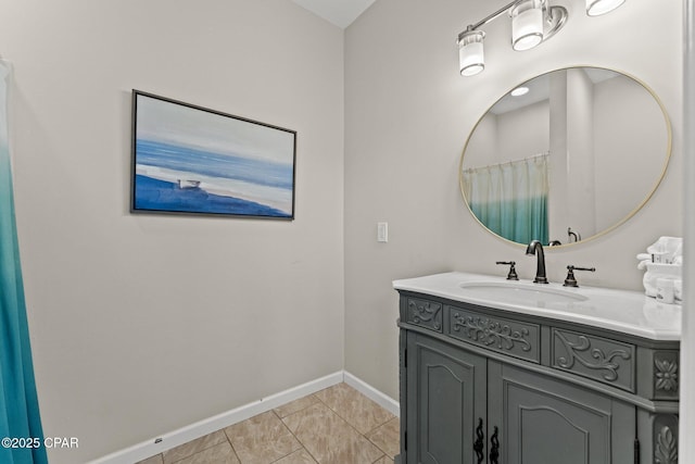 full bathroom featuring baseboards and vanity