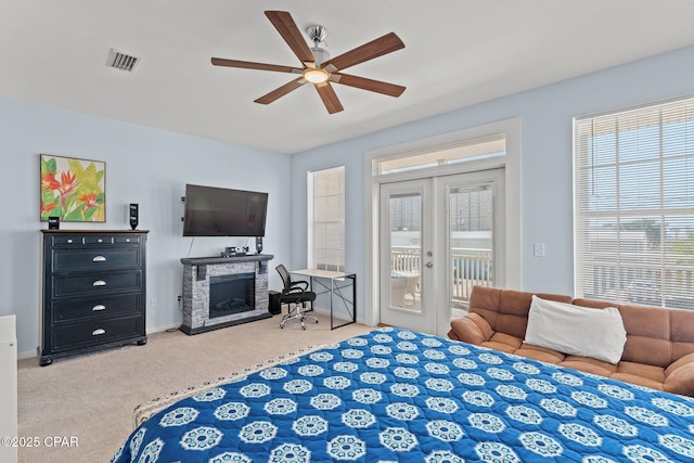 bedroom featuring access to outside, a fireplace, french doors, carpet, and visible vents