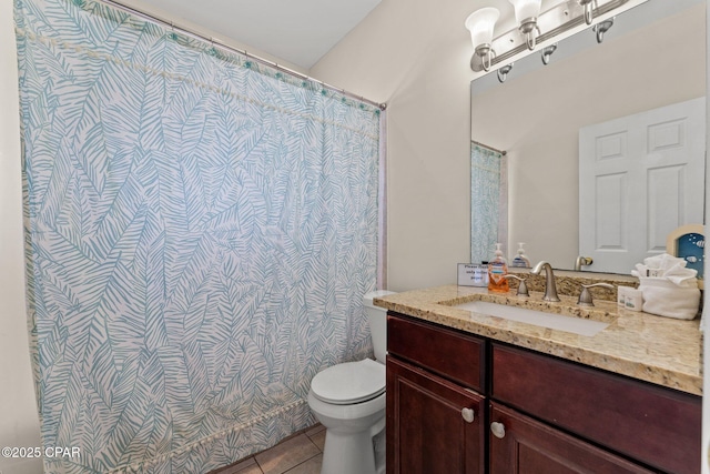 bathroom featuring toilet, tile patterned flooring, and vanity
