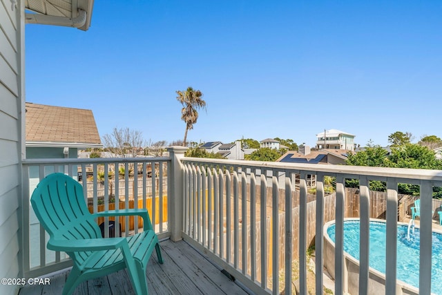 wooden deck with a fenced in pool
