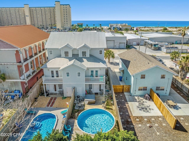 view of swimming pool featuring a fenced in pool, a fenced backyard, french doors, and a water view