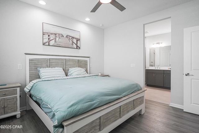 bedroom with baseboards, recessed lighting, wood finished floors, and connected bathroom
