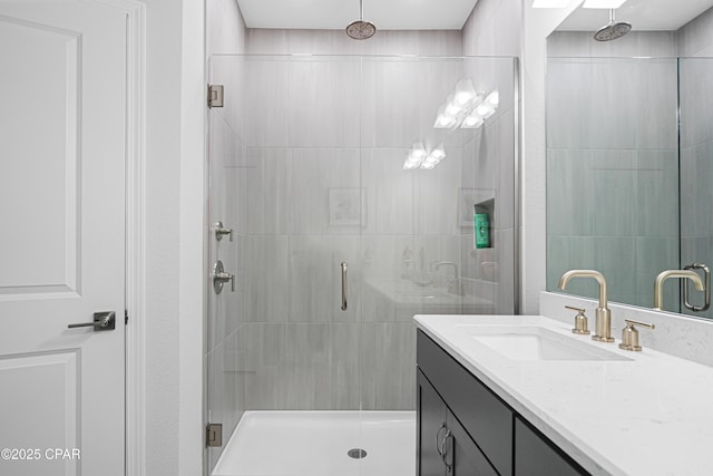 full bath with a shower stall and vanity