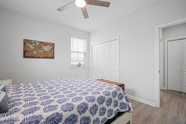 bedroom featuring baseboards, ceiling fan, wood finished floors, and a closet