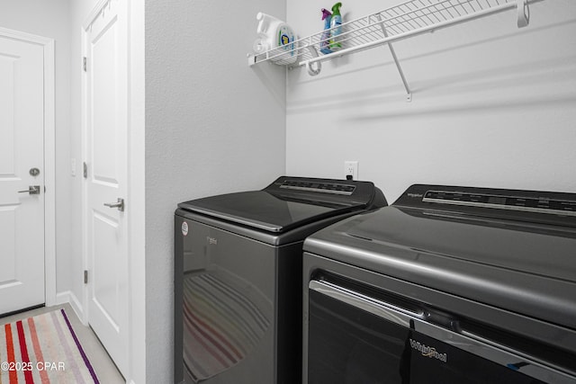 clothes washing area featuring laundry area and washing machine and dryer
