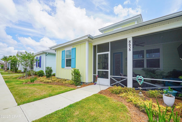 view of exterior entry with a lawn