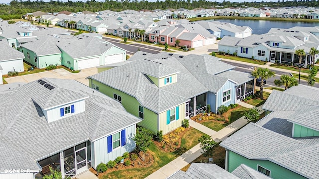 birds eye view of property with a residential view and a water view
