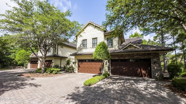 view of front of property featuring a garage and decorative driveway