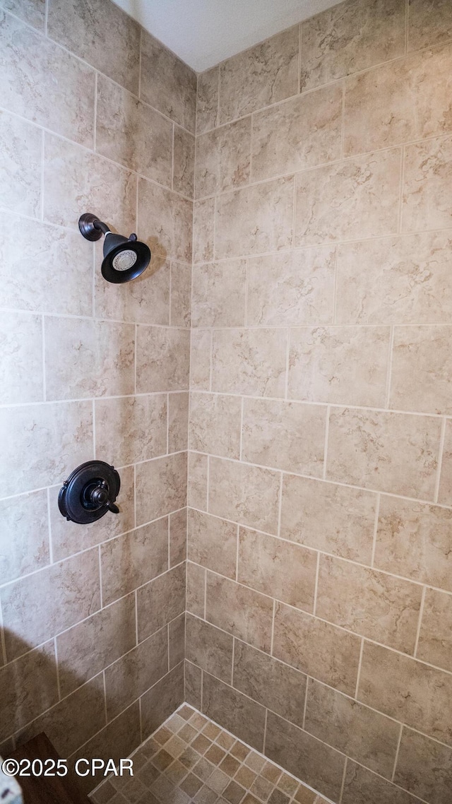 bathroom with tiled shower