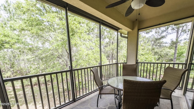 sunroom featuring ceiling fan
