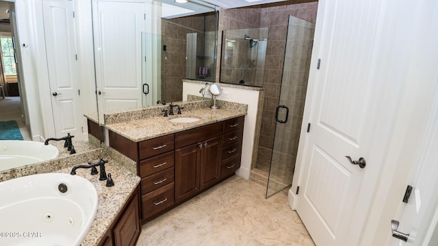 bathroom with vanity, a stall shower, and a tub with jets