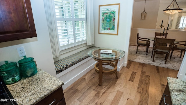 sitting room with baseboards and light wood finished floors