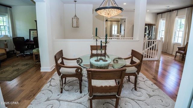 dining space featuring recessed lighting, baseboards, and wood finished floors