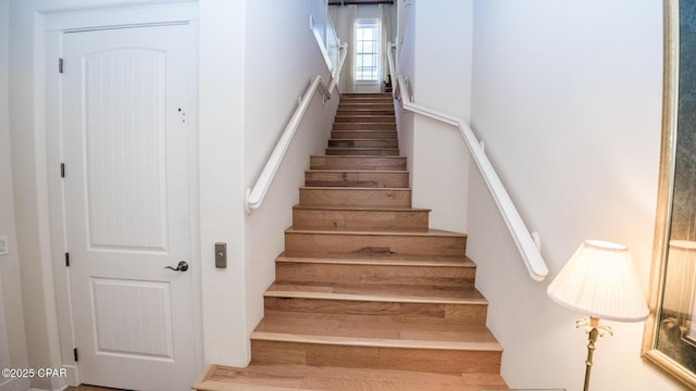 stairway featuring wood finished floors