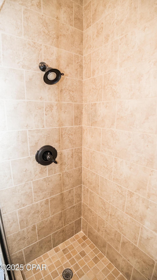 bathroom with a tile shower