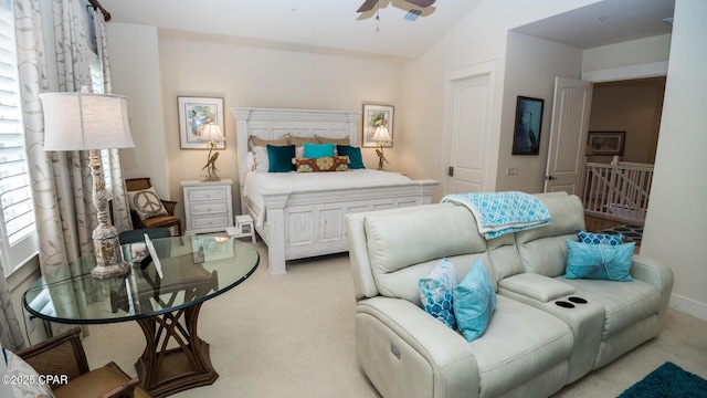 bedroom featuring a ceiling fan, light carpet, and lofted ceiling
