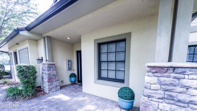 doorway to property featuring stucco siding