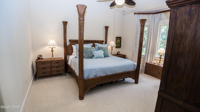 bedroom with baseboards, lofted ceiling, and light colored carpet