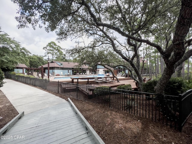 view of home's community featuring fence and a pool