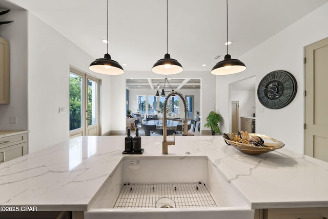 8597 N Lagoon Dr, Panama City, FL 32408 - kitchen with hanging light fixtures, light stone countertops, and recessed lighting