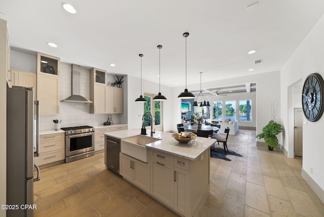8597 N Lagoon Dr, Panama City, FL 32408 - kitchen featuring visible vents, a sink, decorative backsplash, wall chimney range hood, and stainless steel appliances