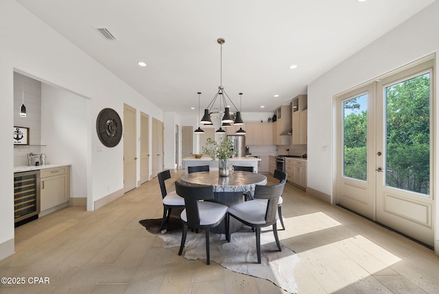 8597 N Lagoon Dr, Panama City, FL 32408 - dining space featuring beverage cooler, visible vents, baseboards, a chandelier, and recessed lighting
