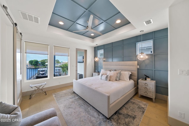 8597 N Lagoon Dr, Panama City, FL 32408 - bedroom with recessed lighting, a barn door, and visible vents
