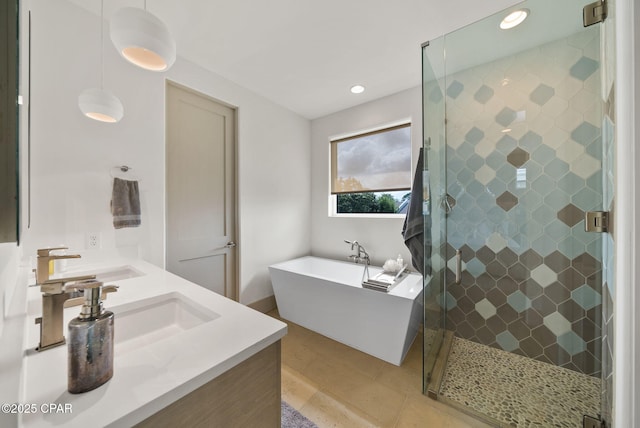 8597 N Lagoon Dr, Panama City, FL 32408 - full bath with recessed lighting, a sink, a shower stall, a soaking tub, and double vanity