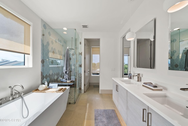 8597 N Lagoon Dr, Panama City, FL 32408 - bathroom with a sink, a wealth of natural light, and tile patterned floors