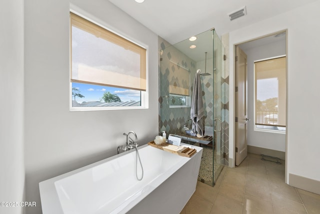 8597 N Lagoon Dr, Panama City, FL 32408 - bathroom with a stall shower, baseboards, visible vents, tile patterned floors, and a freestanding bath