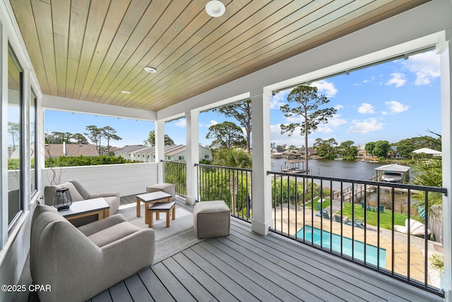 8597 N Lagoon Dr, Panama City, FL 32408 - wooden deck featuring a water view and a fenced in pool