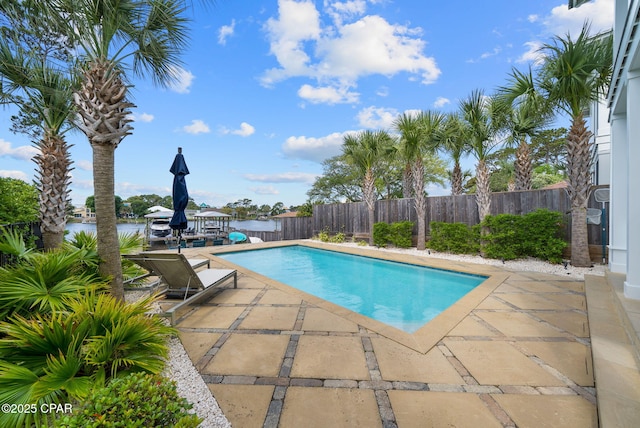 8597 N Lagoon Dr, Panama City, FL 32408 - view of swimming pool featuring a fenced backyard, a water view, a patio, and a fenced in pool