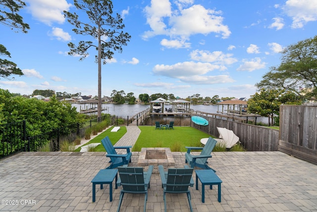 8597 N Lagoon Dr, Panama City, FL 32408 - view of patio / terrace featuring a fire pit, a water view, and a fenced backyard