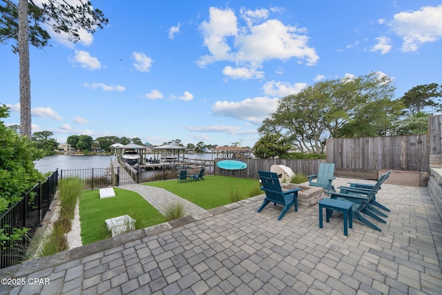 8597 N Lagoon Dr, Panama City, FL 32408 - view of patio featuring a fenced backyard, an outdoor fire pit, boat lift, and a water view