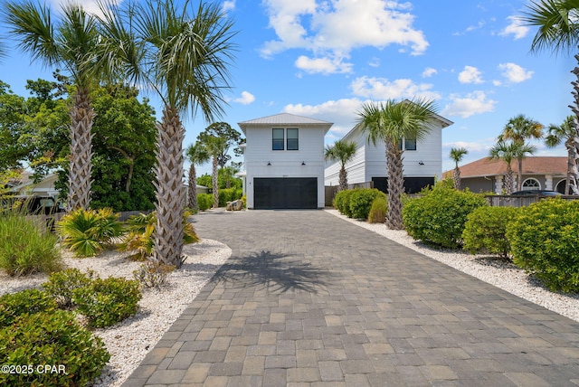 8597 N Lagoon Dr, Panama City, FL 32408 - view of side of property featuring decorative driveway and a garage