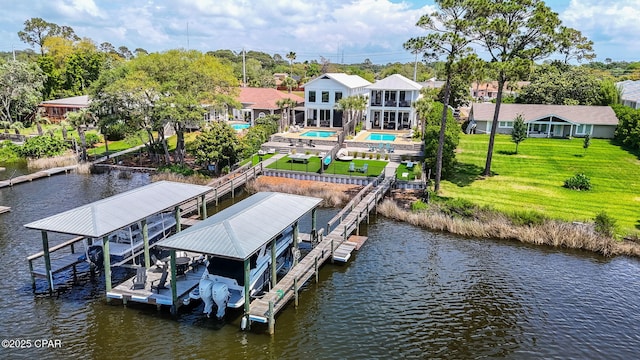 8597 N Lagoon Dr, Panama City, FL 32408 - view of dock with a water view, a yard, an outdoor pool, and boat lift