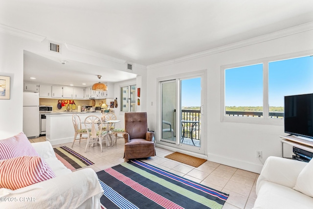 living area with light tile patterned floors, baseboards, ornamental molding, and visible vents