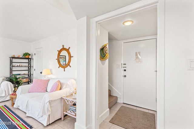 entryway with stairs, ornamental molding, and light tile patterned floors