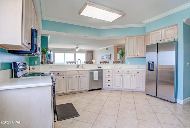 8601 Surf Dr Unit 14E, Panama City, FL 32408 - kitchen with crown molding, a sink, light countertops, stainless steel appliances, and light tile patterned floors