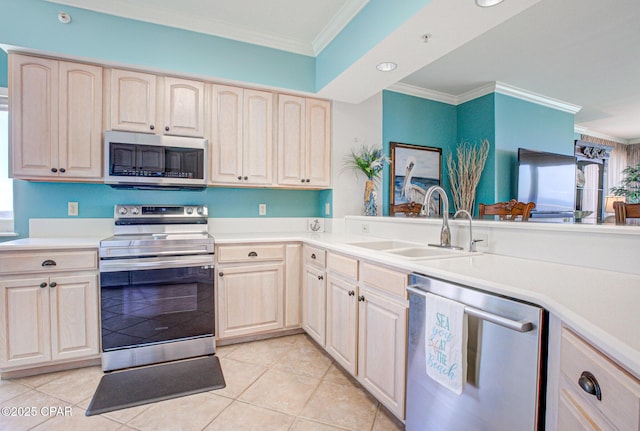 8601 Surf Dr Unit 14E, Panama City, FL 32408 - kitchen featuring crown molding, stainless steel appliances, a sink, and light countertops