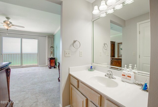 8601 Surf Dr Unit 14E, Panama City, FL 32408 - bathroom featuring crown molding, vanity, ceiling fan, and baseboards