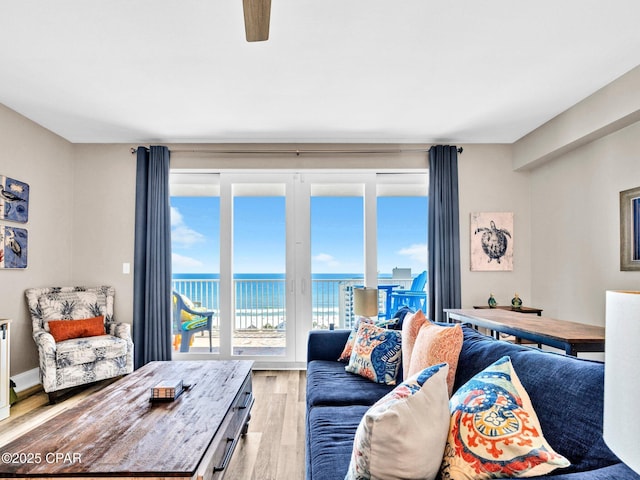 9860 S Thomas Dr Unit 1202, Panama City Beach, FL 32408 - living area with light wood-type flooring, a water view, and a ceiling fan