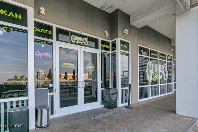 9860 S Thomas Dr Unit 1202, Panama City Beach, FL 32408 - doorway to property featuring french doors and stucco siding
