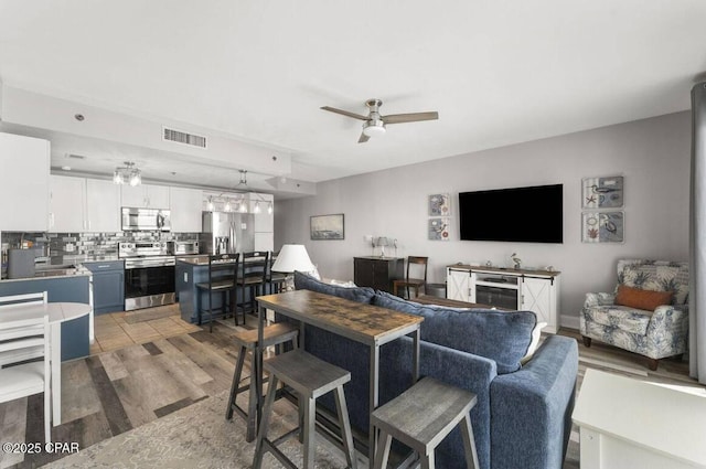 9860 S Thomas Dr Unit 1202, Panama City Beach, FL 32408 - living area featuring light wood-style flooring and ceiling fan