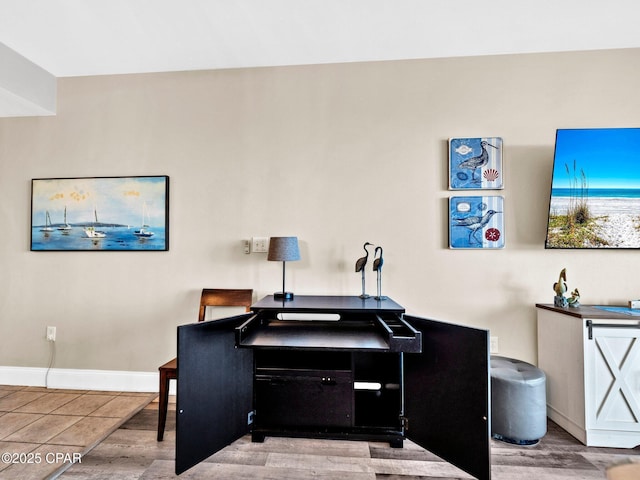 9860 S Thomas Dr Unit 1202, Panama City Beach, FL 32408 - home office featuring wood finished floors and baseboards
