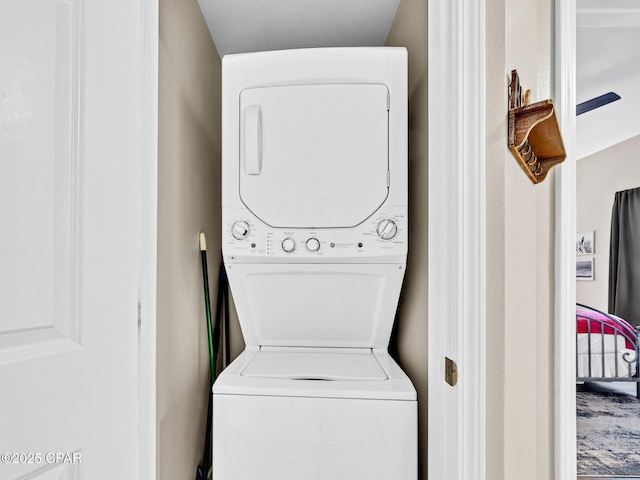 9860 S Thomas Dr Unit 1202, Panama City Beach, FL 32408 - clothes washing area featuring stacked washer / drying machine