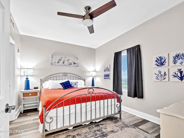 9860 S Thomas Dr Unit 1202, Panama City Beach, FL 32408 - bedroom featuring wood finished floors, baseboards, and a ceiling fan